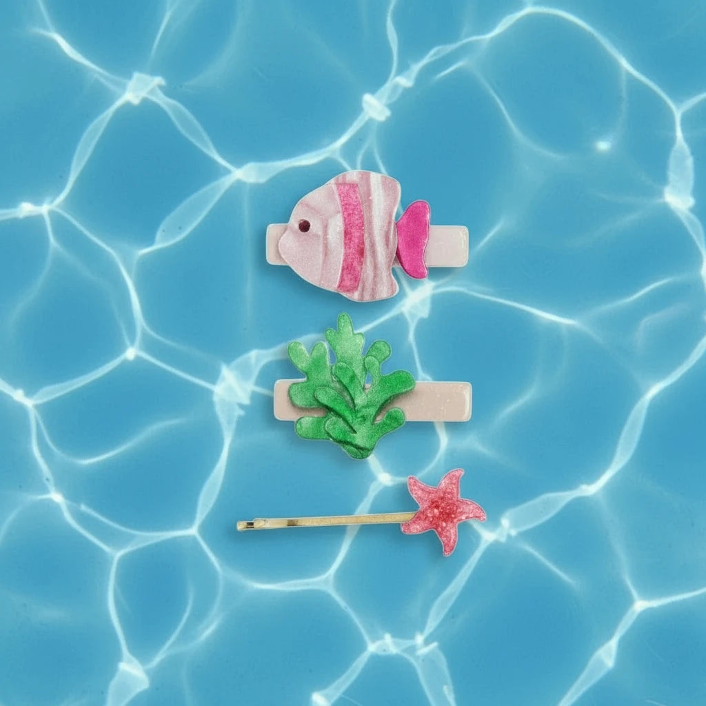 Set of three decorative hair clips shaped like a fish, coral, and starfish on a white background.